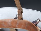 a close up of a helmet with a leather strap