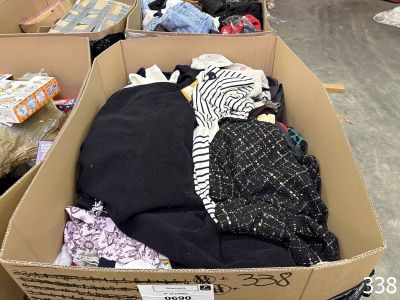 a cardboard box filled with lots of clothes in a store