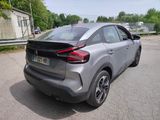 the rear end of a silver car parked in a parking lot