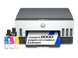 a printer with ink cartridges and ink bottles on a white background