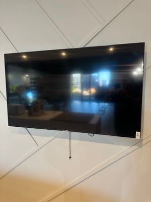 a flat screen tv mounted on a wall in a living room