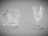 two glass cups sitting next to each other on a table
