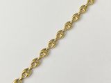 a close up of a gold chain on a white surface