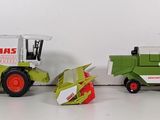 two toy tractors that are sitting next to each other