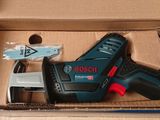 the box is open with a cordless drill and other tools in it