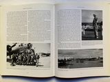 an open book with pictures of military men standing in front of a plane