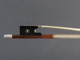 a close up of a violin bow with a string attached to it