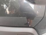 a man that is standing on the side of a car