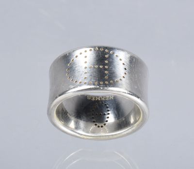 a close up of a silver ring with dots on it