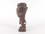 an old wooden statue of a man with a hat on it ' s head