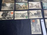 many old postcards of old buildings on the table