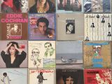 many different album covers on the wall of a room
