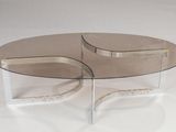 pair of clear glass coffee tables with curved bases