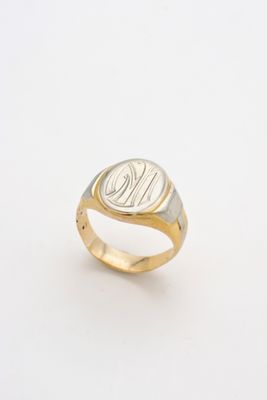 a close up of a gold ring with a monogram on it