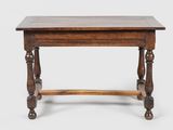 an old wooden table with turned legs and a wooden top
