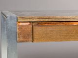 a close up of a wooden table with a metal base