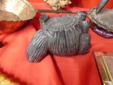 a turtle made out of clay on a red cloth