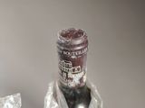 a bottle of wine that is wrapped in plastic