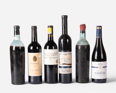 several bottles of wine are lined up in a row on a white surface