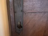 a close up of a door handle on a wooden door