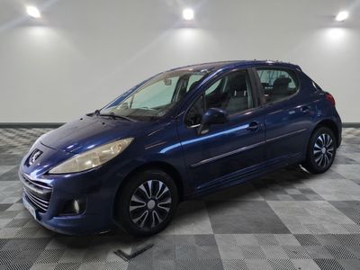 a blue car is parked on a checkered floor in a garage