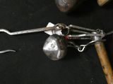 a pair of tonges and a hammer on a black table