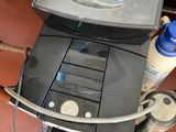a television sitting on top of a desk next to a chair