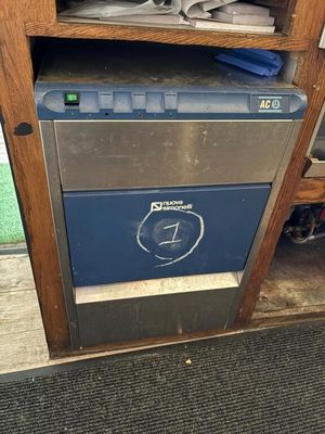 a blue and silver dishwasher sitting on a wooden shelf