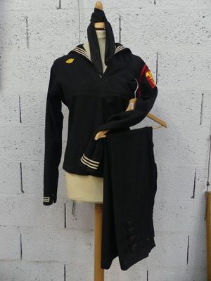 a mannequin with a uniform on it next to a wall