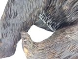 a statue of a bear that is sitting on the ground