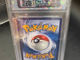 a close up of a pokemon trading card in a clear box