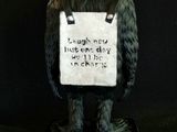 a statue of a gorilla with a sign on it ' s back