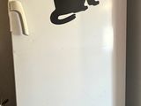 a white refrigerator with a black cat decal on it