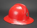 a red fireman ' s helmet on a black background