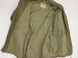 an image of a military jacket hanging on a wall