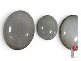 three large gray rocks sitting next to each other on a white surface