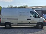 a silver van that is parked in a parking lot