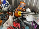a pile of skis and ski poles in a garage