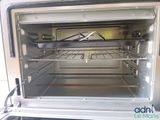 an open oven with a rack in the middle of it