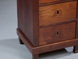an image of a wooden chest of drawers on a gray background