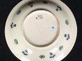 a white plate with blue and green designs on it