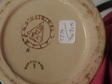 someone is holding a plate with a picture of a man on it