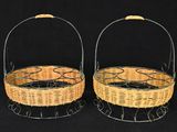 two wicker baskets with handles on a black background