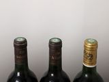 three bottles of wine are lined up on a table