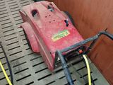 a red machine that is sitting on the floor