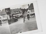 a black and white photo of a couple of people on a street