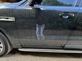 a black car with a person standing in the door