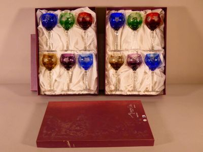 four wine glasses in a box on a table