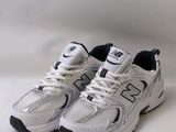 the new balance 991 is a white sneak with black accents