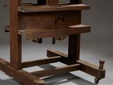 a wooden table with two drawers on wheels